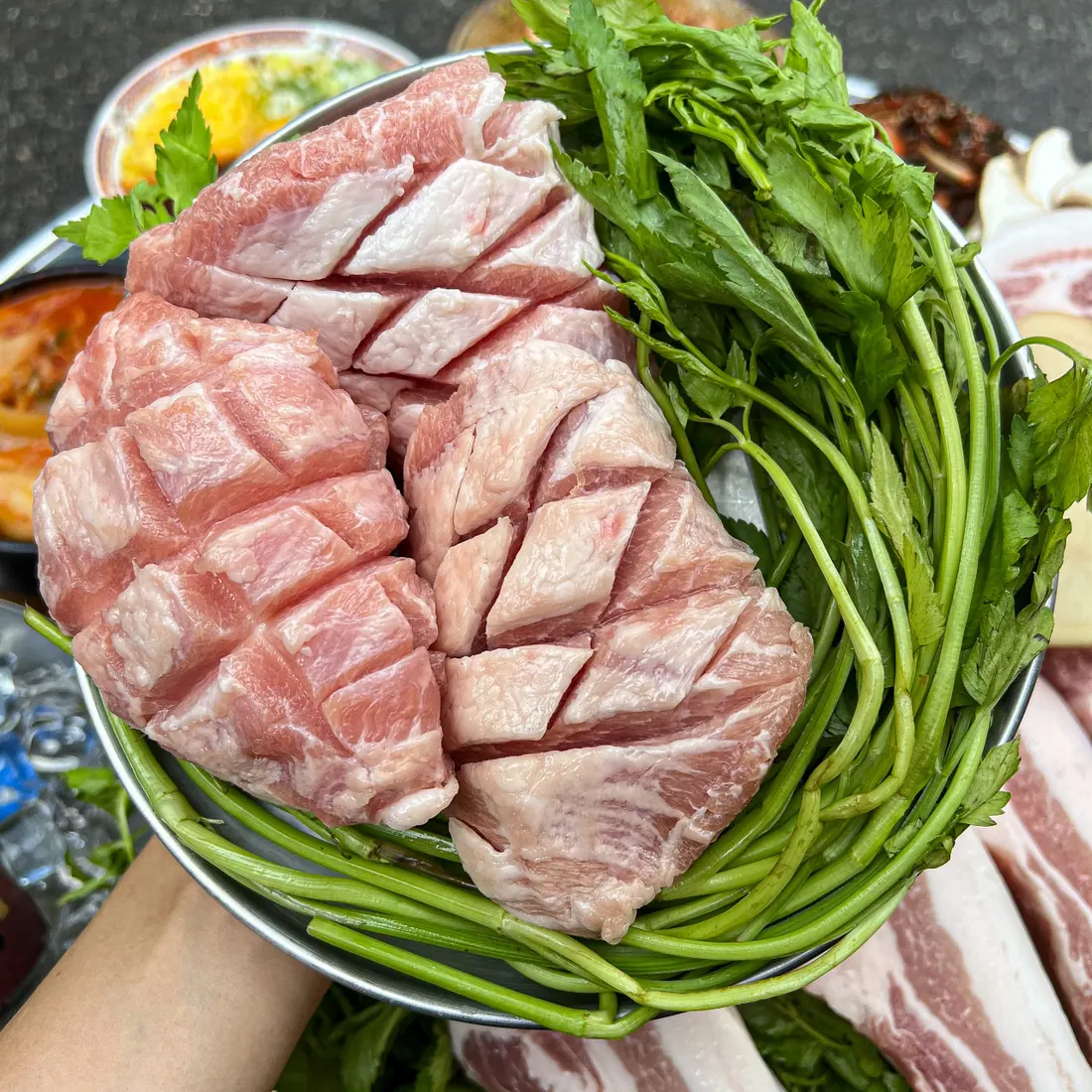Scored thick-cut aged pork belly ringed with minari · 이태원 고기집 · Itaewon Restaurants